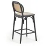 Барный стул Doriane из цельного вяза высотой 65 см с черным лаком и мягким сиденьем